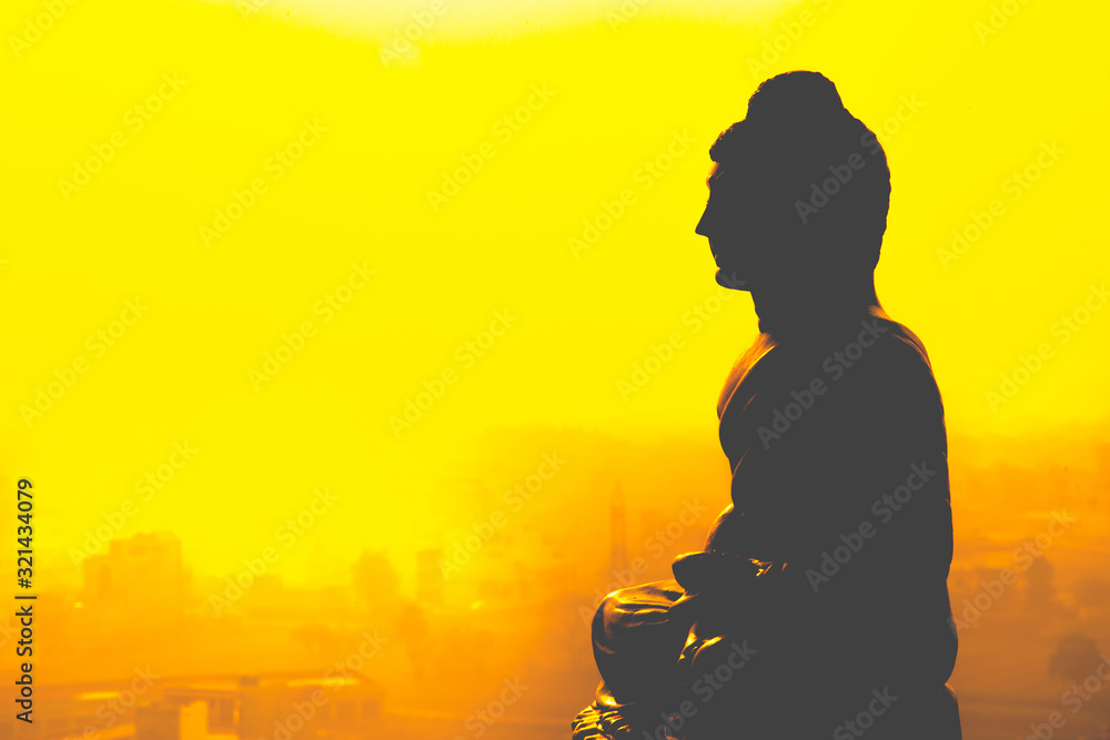 silhouette of  Buddha  in sunset