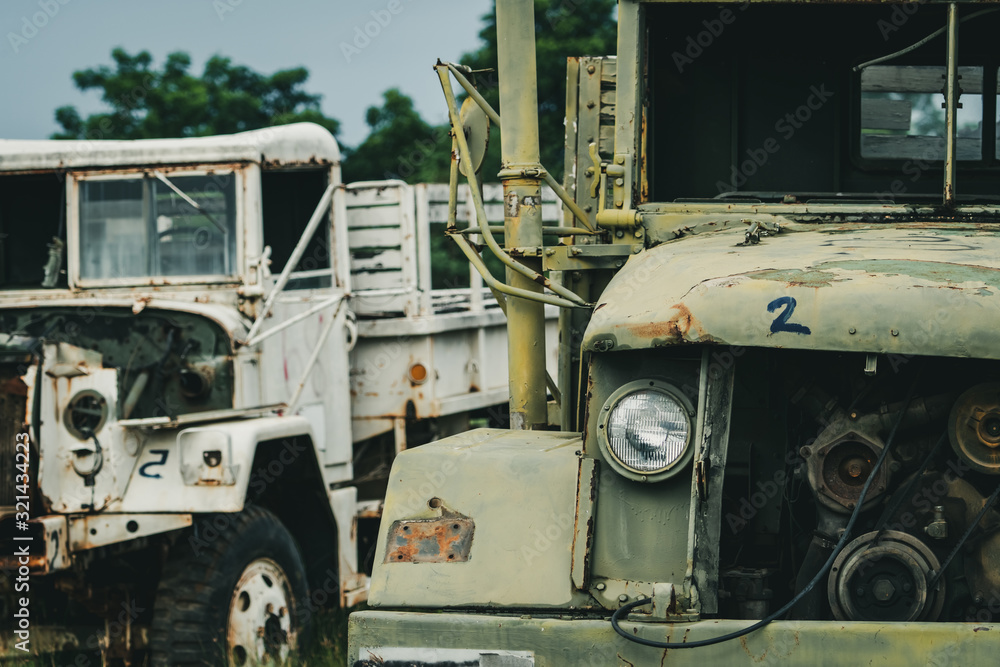 Old wrecked white and green truck. Abandoned rusty military truck. Decayed abandoned truck. Tragedy and loss. Financial crunch and economic recession concept. Old decayed lorries. Transportation.