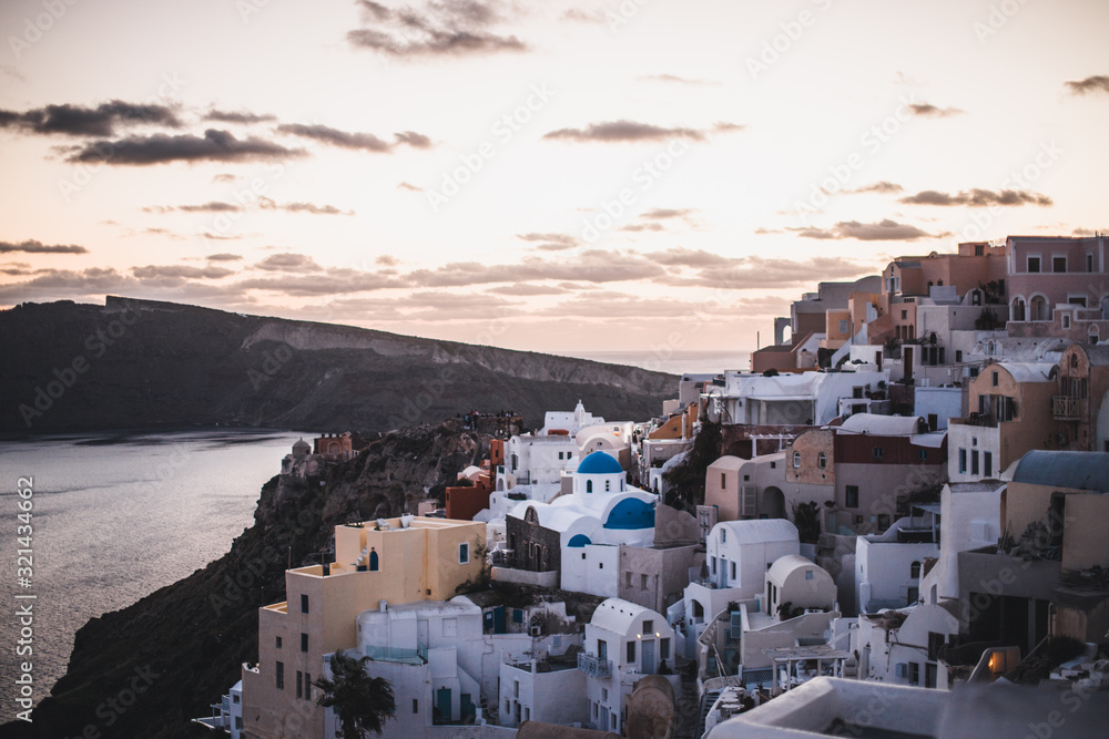 view of whitewashed houses and blue dome in oia Santorini Greece
