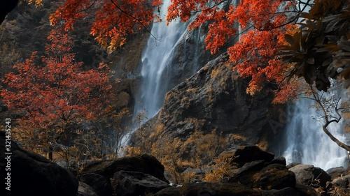 Still shot of amazing in nature, beautiful waterfall at colorful autumn forest in fall season