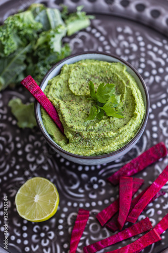 Delicious green healthy dip with beetroot sticks