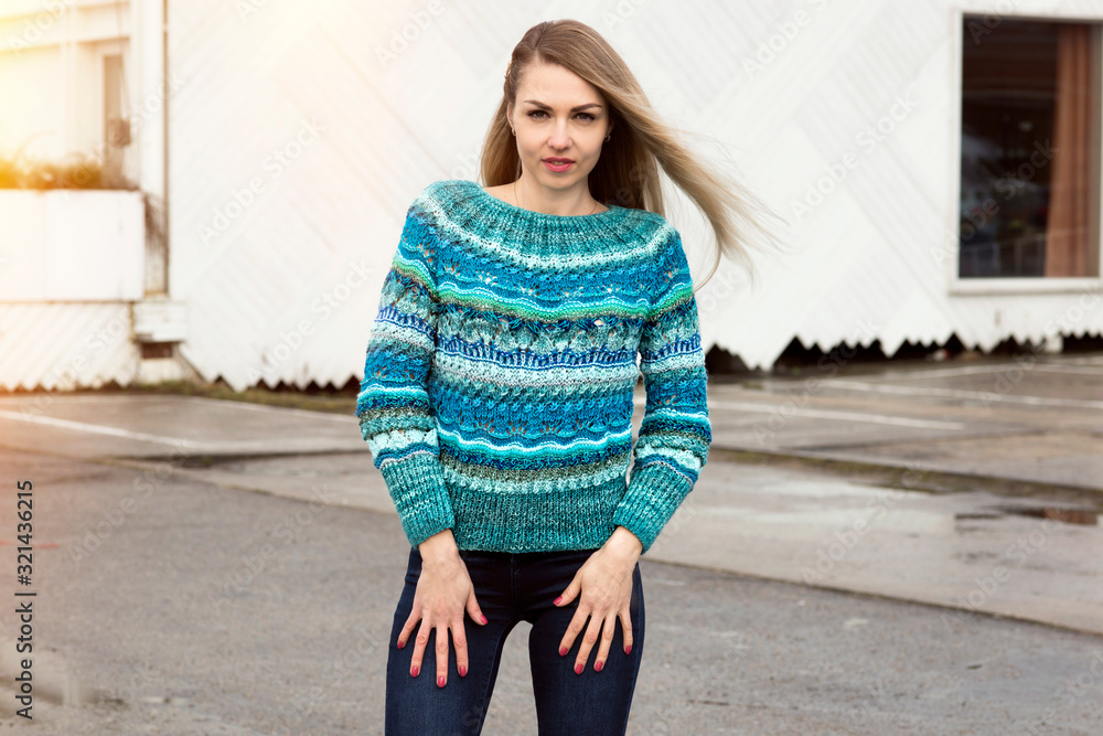 Fototapeta premium Woman posing in a fashionable knitted blue sweater