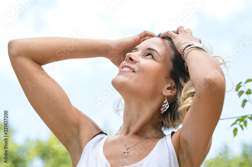 Portrait of a blonde girl in a summer park.