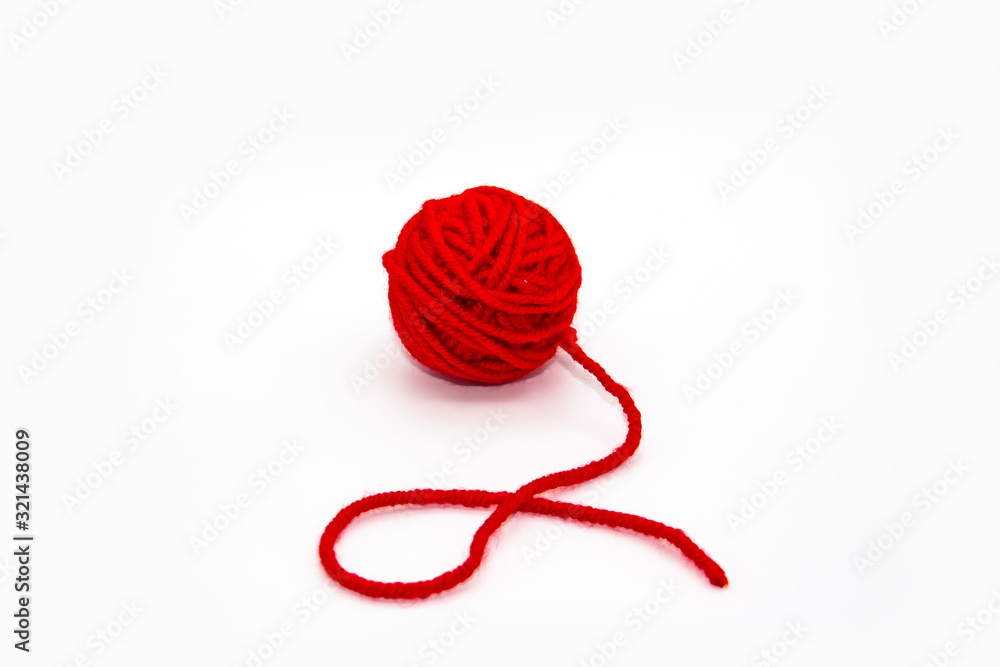 Red skein of thread against white background. Red ball of wool red thread isolated on white