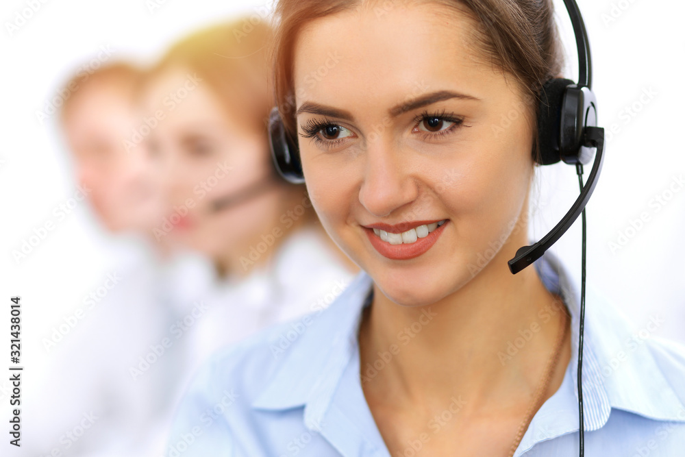 Call center. Focus on beautiful business woman using headset in sunny office Call center. Focus on beautiful business woman using headset in sunny office