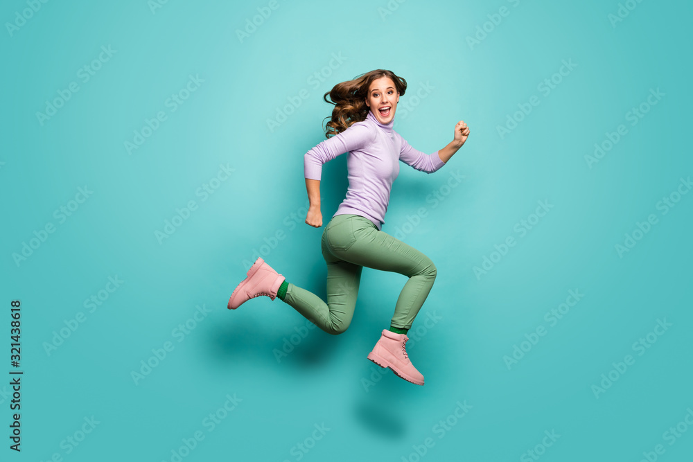 Full body profile photo of crazy beautiful lady jump high up speed rushing black friday addicted shopper wear purple jumper green pants footwear isolated teal pastel color background