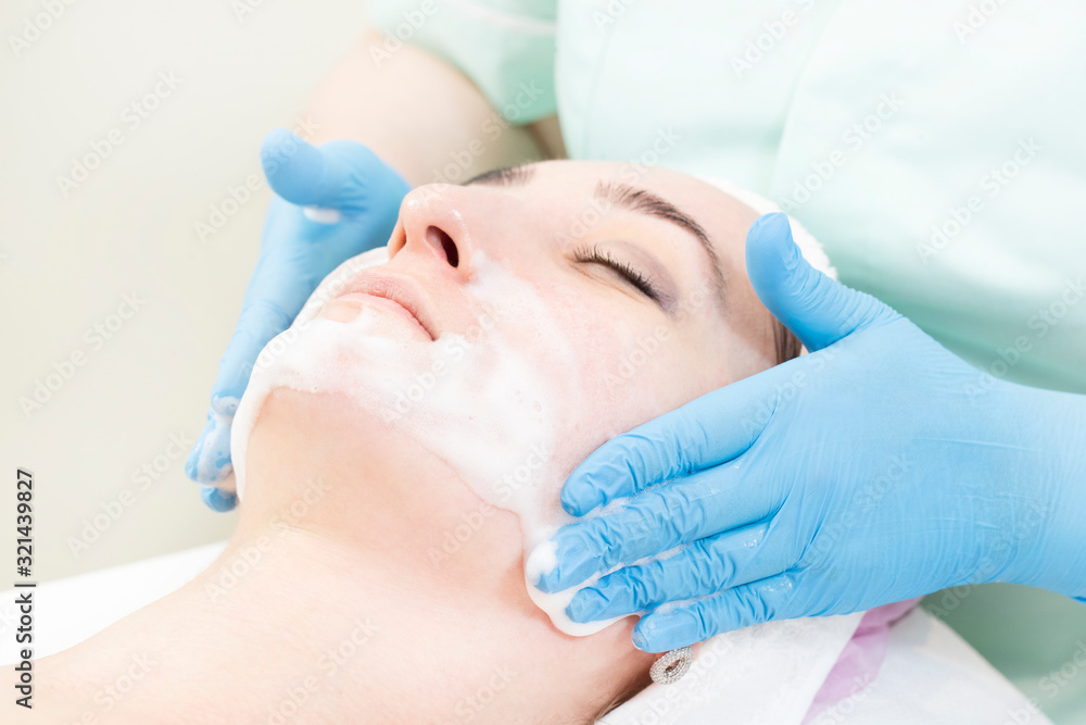 Procedure female cosmetic mask and chistak face in a beauty salon. Procedure female cosmetic mask and chistak face in a beauty salon.
