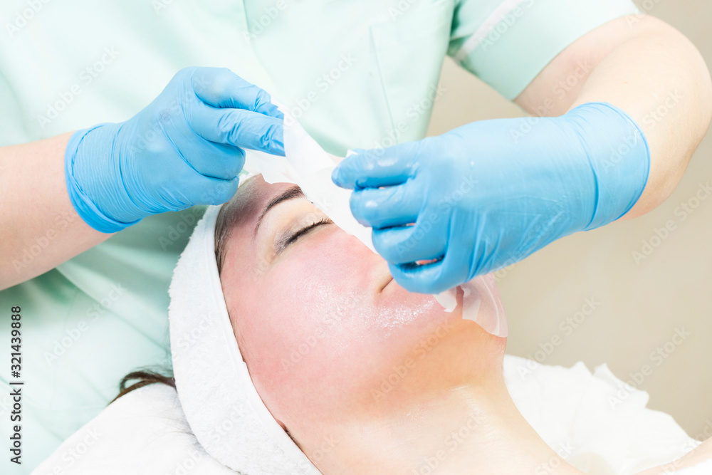 Procedure female cosmetic mask and chistak face in a beauty salon. Procedure female cosmetic mask and chistak face in a beauty salon.