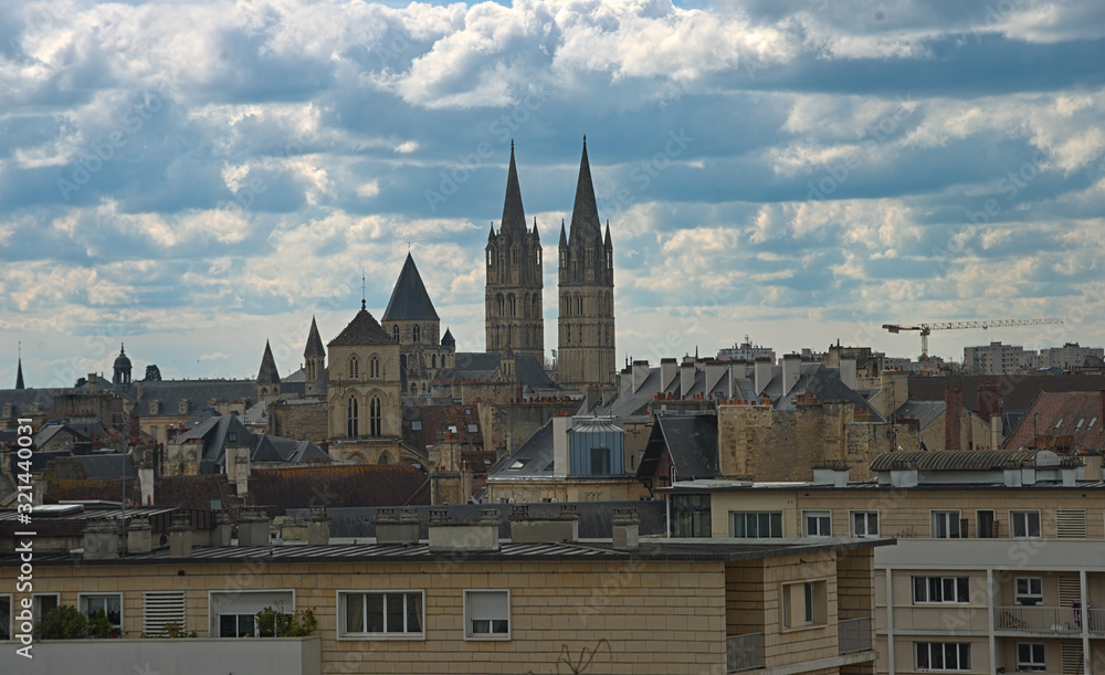 Cityscape of French city Caen with high tower of an catholic cathedral