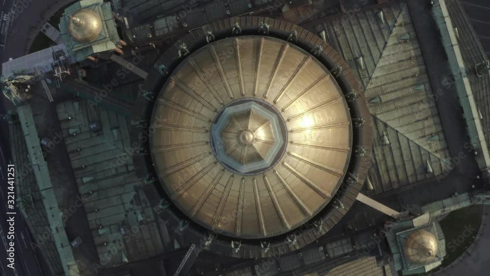 top view of the round and golden dome of the cathedral, next to which is the road that cars drive top view of the round and golden dome of the cathedral, next to which is the road that cars drive