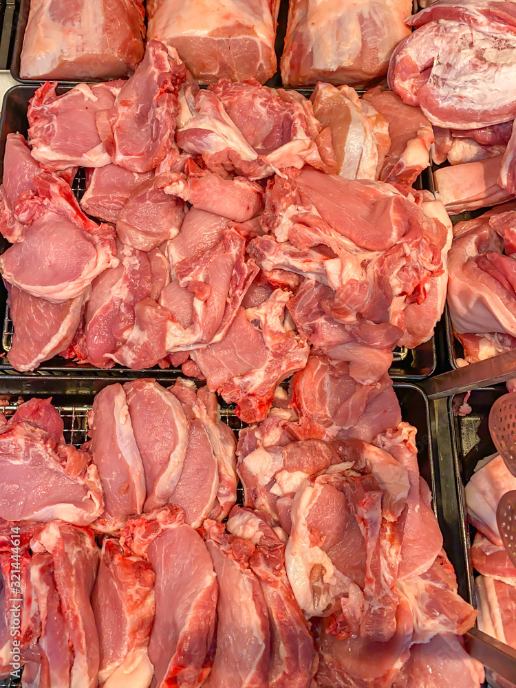Pile of raw cutlet pork meat for sale at supermarket