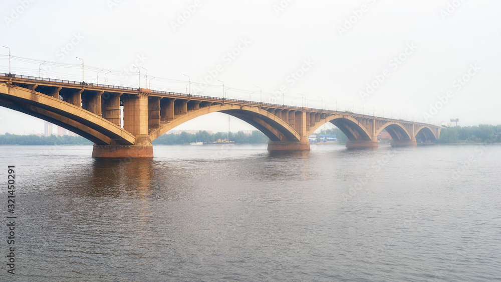Fototapeta premium Communal bridge over the Yenisei river in Krasnoyarsk during the foggy weather