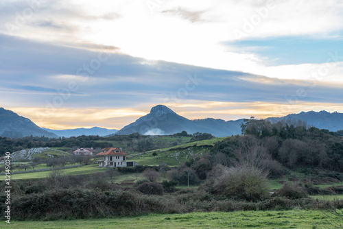 Beautiful landscape at sunset in Principado de Asturias  Spain  Picos de Europa region  near Ribadesella  with a majestic mountain peak silhouette on the background.