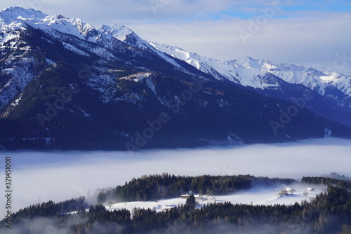 beautiful sunrise in the mountain with fog in the valley and view to the alps