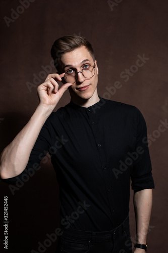 Man in round glasses and a black shirt. © Александр Пугач