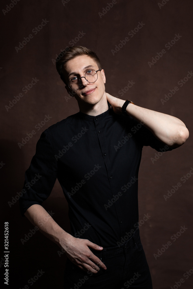 Man in round glasses and a black shirt. Man in round glasses and a black shirt.