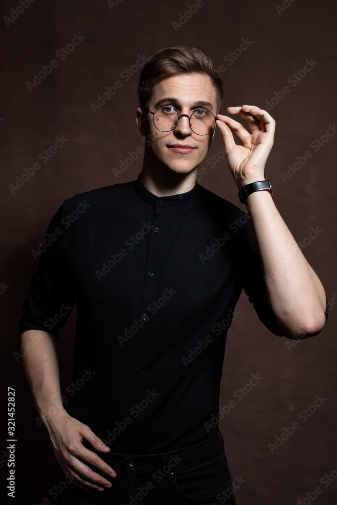 Man in round glasses and a black shirt. Man in round glasses and a black shirt.