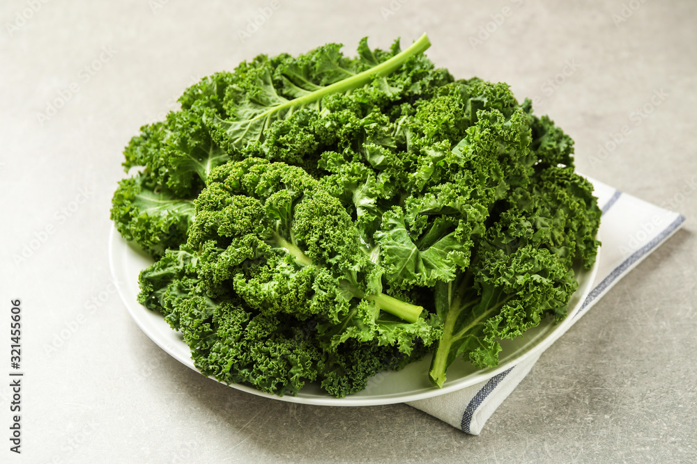 Fresh kale leaves on light grey table Fresh kale leaves on light grey table