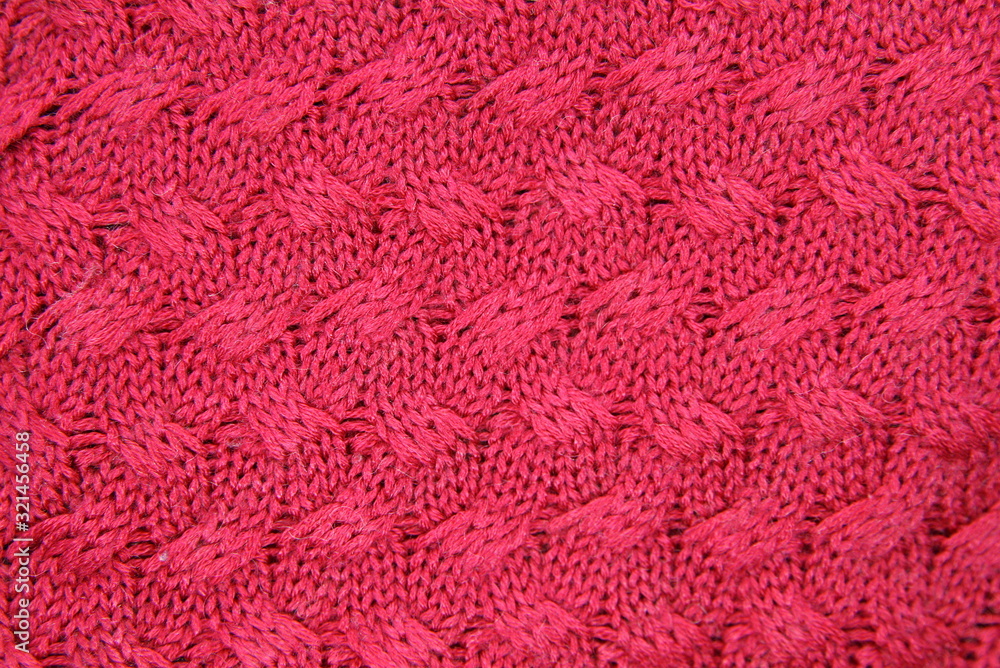 background red knitted pigtails made of wool yarn background red knitted pigtails made of wool yarn