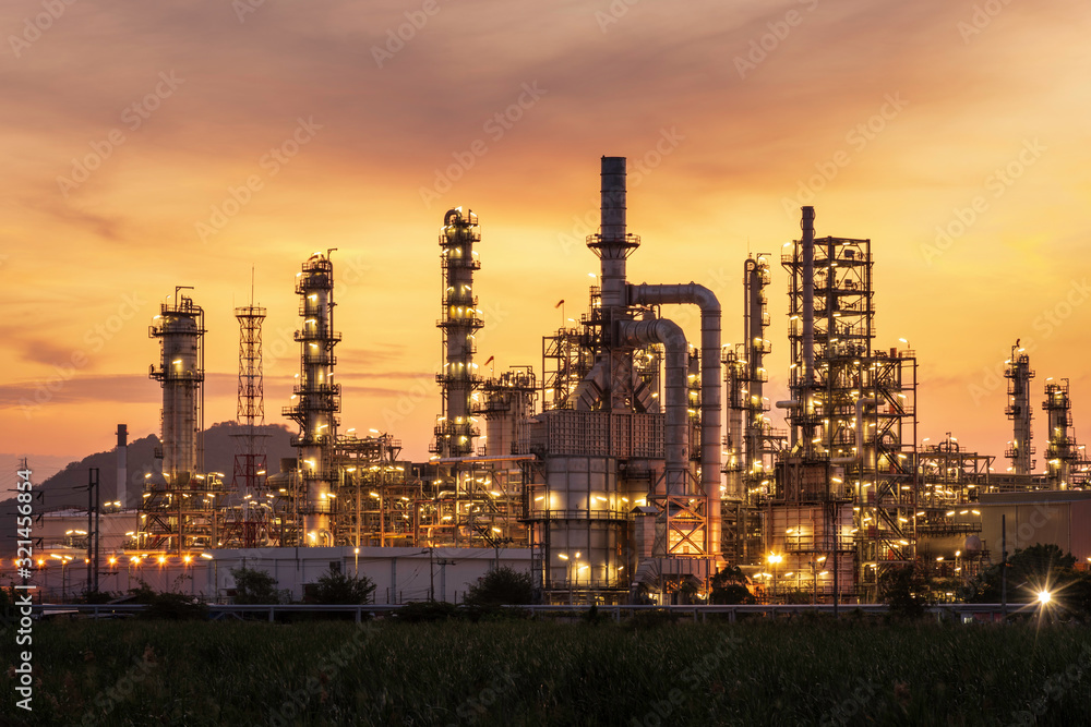 oil refinery and natural gas storage tank at yellow sunrise