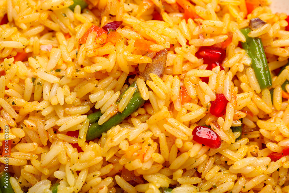 Tasty rice pilaf with vegetables as background, closeup Tasty rice pilaf with vegetables as background, closeup