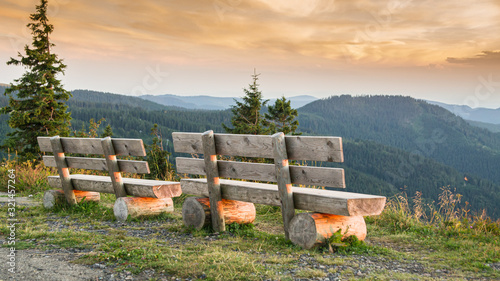Benches on the Feldberg with a view over hazy hills.