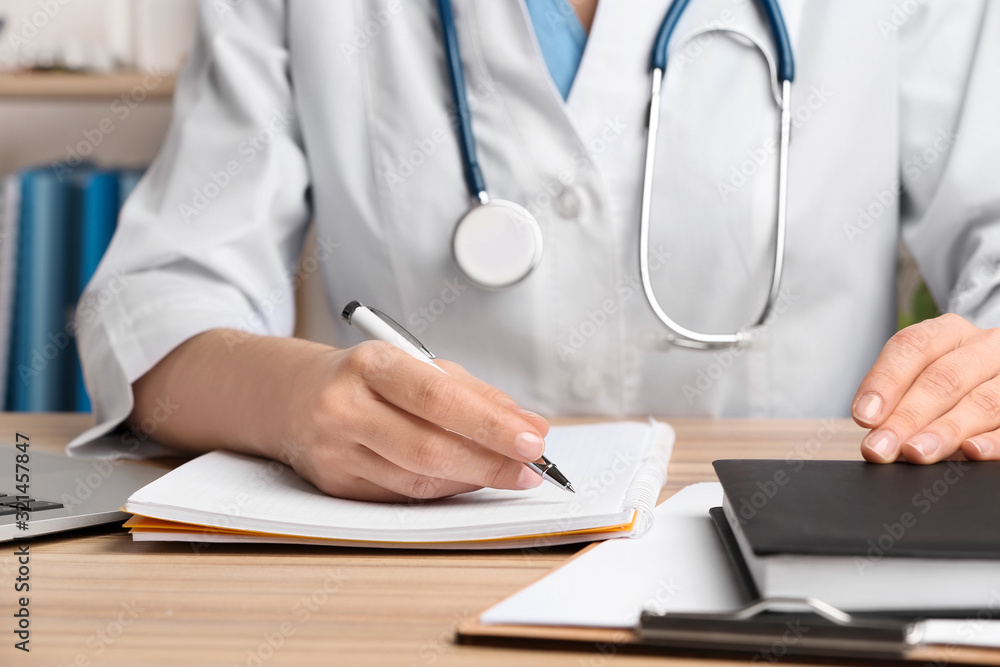 Doctor working at desk in office, closeup. Medical service Doctor working at desk in office, closeup. Medical service