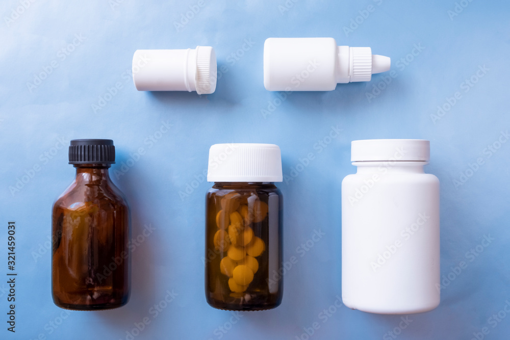 Packaging design concept. Set with various medical bottles on blue background. Pharmacy concept. Health cure collection. Packaging design concept. Set with various medical bottles on blue background. Pharmacy concept. Health cure collection.