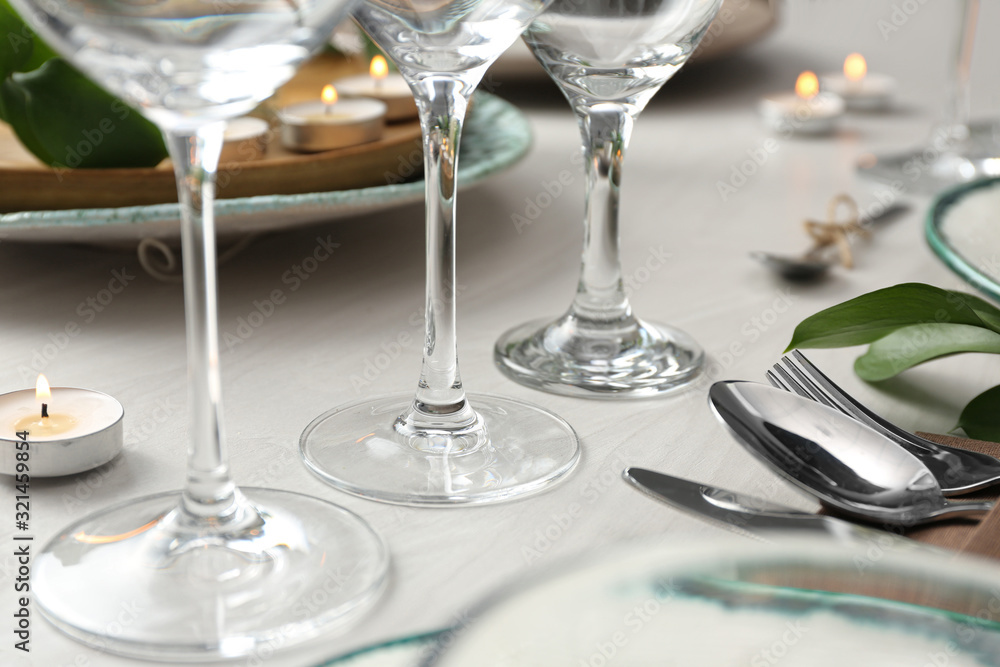 Clean glasses on decorated table. Festive setting Clean glasses on decorated table. Festive setting