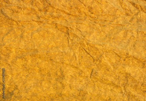 Crumpled yellow paper texture. Abstract background.