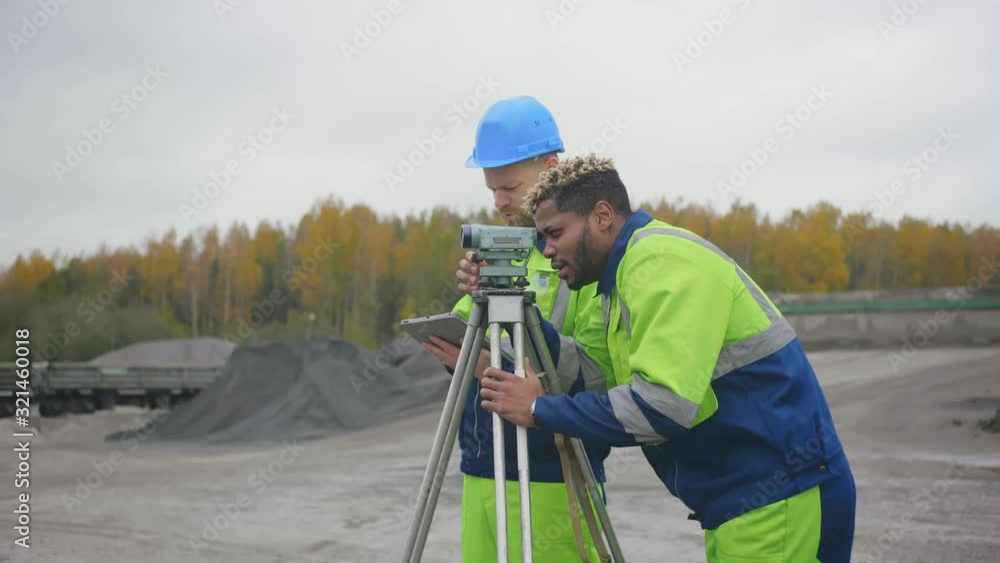 Surveyor engineer making measures with tablet pc to record data. Surveyor engineer making measures with tablet pc to record data.