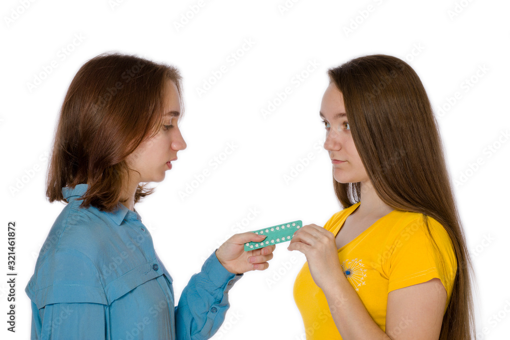 One girl aged 14 gives birth control pills against a white background