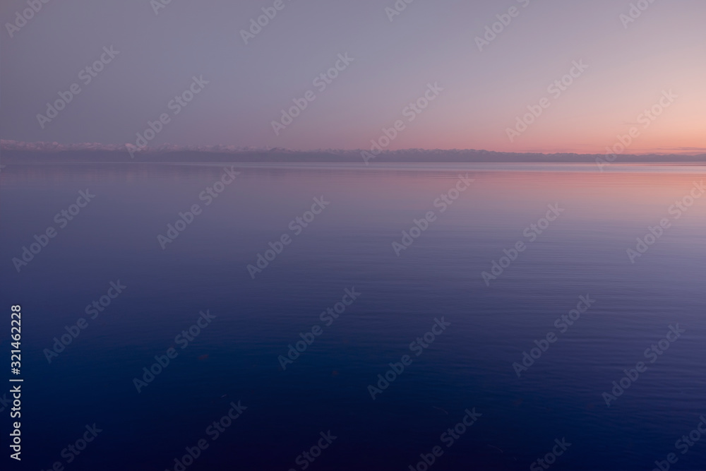 Sunset on Issyk-kol lake, Kyrgyzstan. Lake in the mountains. Lake with mountains background.