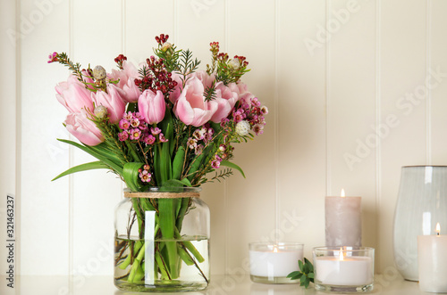 Beautiful bouquet with spring pink tulips on shelf