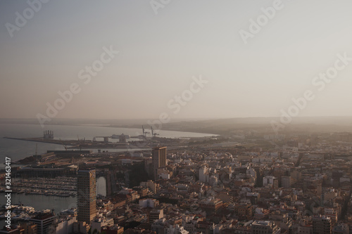 Alicante city and port panorama in haze at sunset in September 