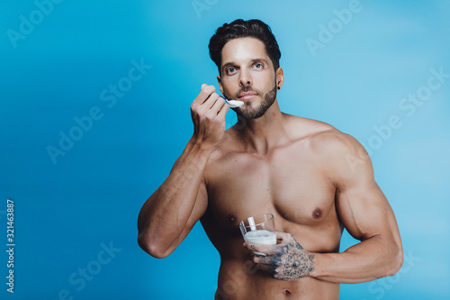 Healthy man eating a yogurt