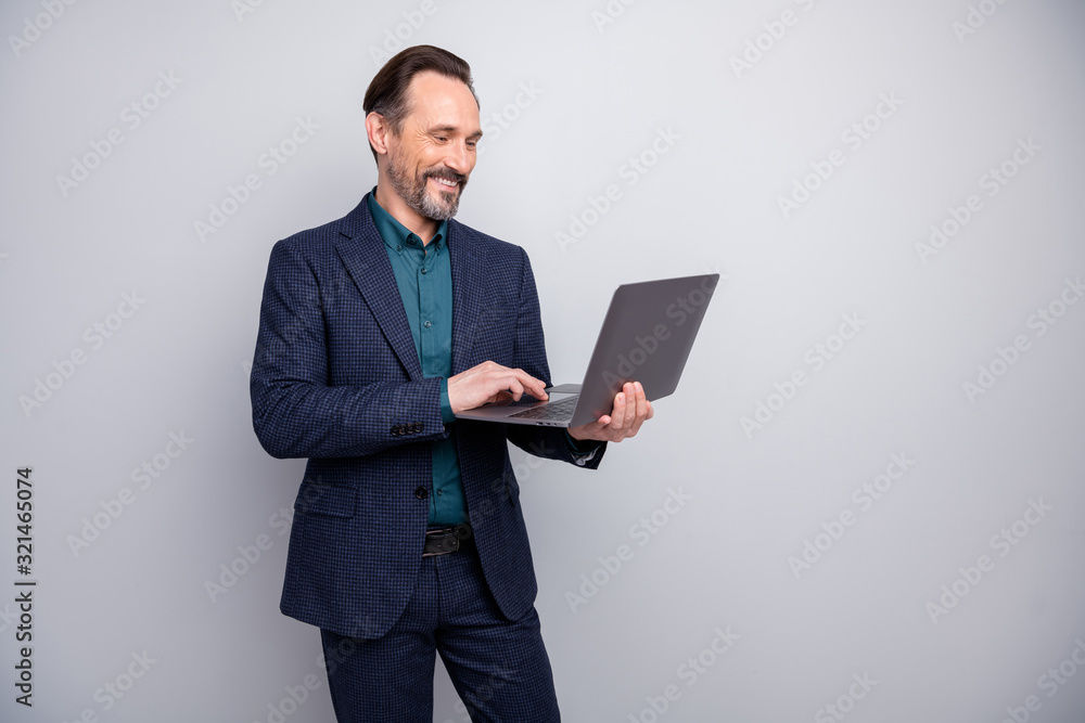 Photo of attractive business man holding notebook reading colleagues report email friendly good mood formalwear blazer shirt pants blue suit isolated grey color background Photo of attractive business man holding notebook reading colleagues report email friendly good mood formalwear blazer shirt pants blue suit isolated grey color background