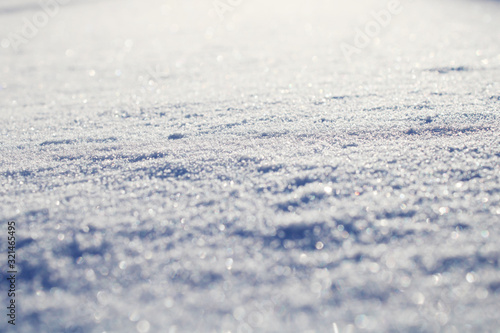 Abstract background. Shining snow. Snow covered field. Close-up of a snowdrift.
