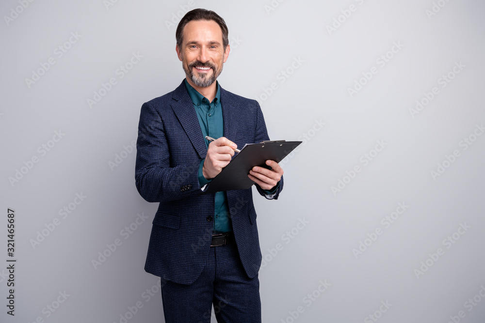 Photo of attractive luxury business manager man read contract clipboard signing pen agreement deal formalwear blazer shirt pants blue suit isolated grey color background Photo of attractive luxury business manager man read contract clipboard signing pen agreement deal formalwear blazer shirt pants blue suit isolated grey color background