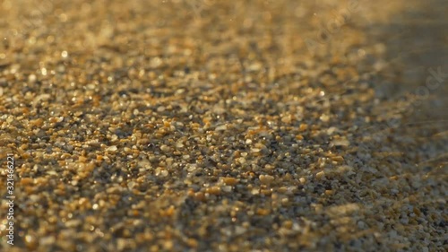 Macro shot of sand particles blown away by the wind. Slow motion shot photo