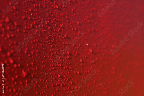 Droplets pattern on red backdrop. Juice splash. Red juicy surface drops  great design for any purposes. Texture background  pattern. Summer bright background. Bright sweet color.