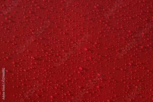 Droplets pattern on red backdrop. Juice splash. Red juicy surface drops, great design for any purposes. Texture background, pattern. Summer bright background. Bright sweet color.