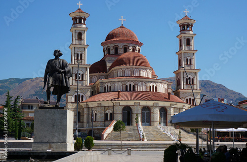 Statue of an Albanian warrior, Orthodox Cathedral in background. Korca (Korce), Albania
