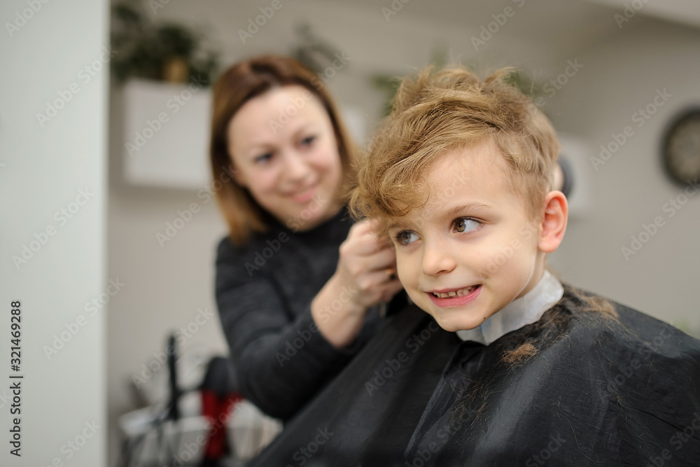 Close up picture of boy/child kid, sitting in the hairdressing salon Close up picture of boy/child kid, sitting in the hairdressing salon