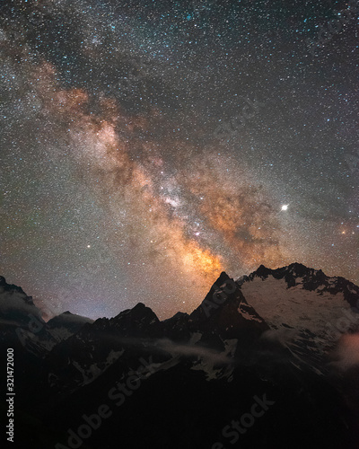 night sky with stars Milky Way over the mountains of the Caucasus with clouds