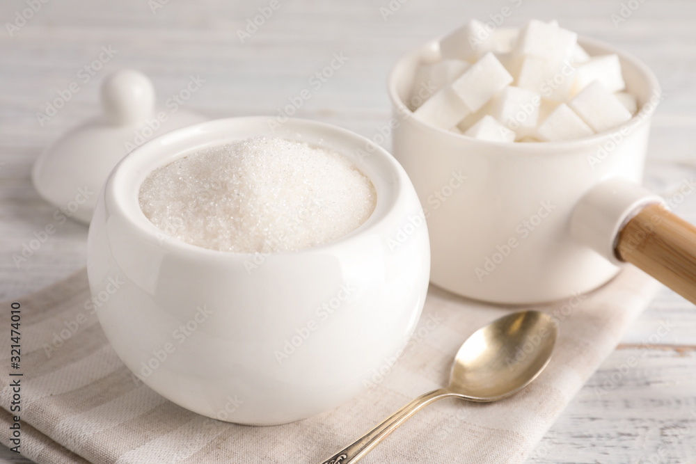 Dishware with sugar on white wooden table Dishware with sugar on white wooden table