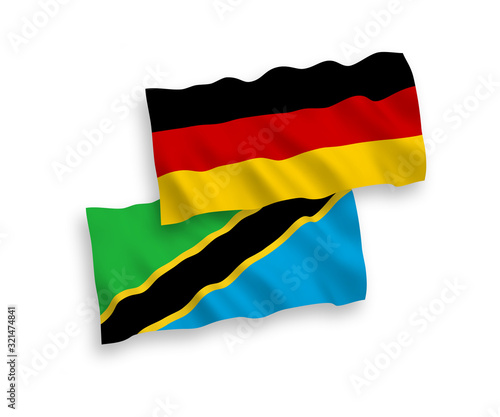 National vector fabric wave flags of Germany and Tanzania isolated on white background. 1 to 2 proportion.