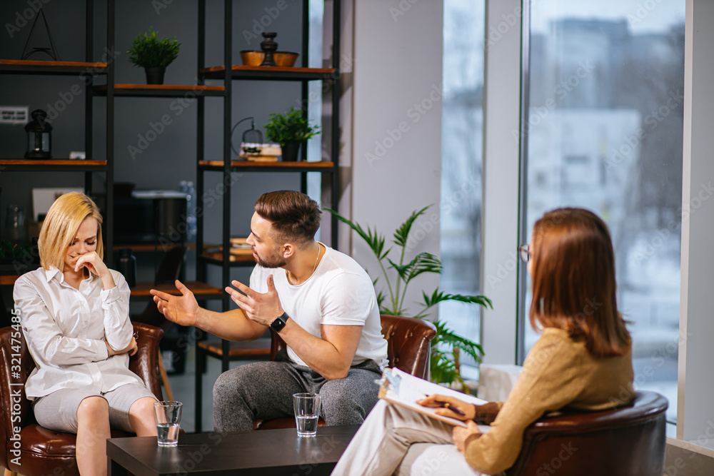 disagreement, people relationships concept. married couple discussing problems at therapy with psychologist, sit attentively listen to irritated give advice, support, possible solutions to problems disagreement, people relationships concept. married couple discussing problems at therapy with psychologist, sit attentively listen to irritated give advice, support, possible solutions to problems