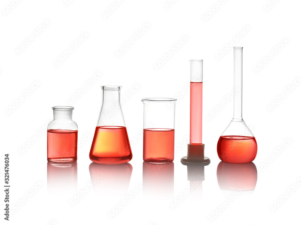 Different laboratory glassware with red liquid isolated on white