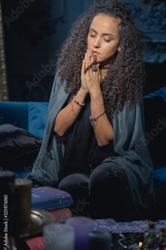 Cuadro en lienzo Focused young lady reciting mantras at home